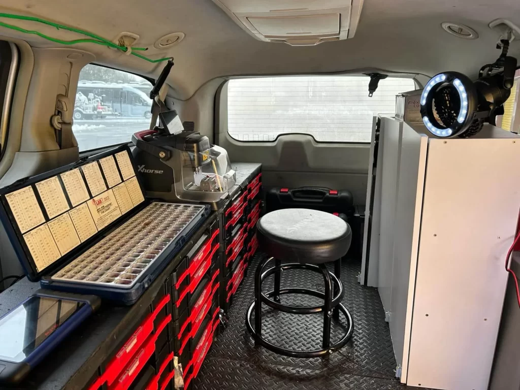 Fully equipped mobile locksmith van with key cutting and programming tools.