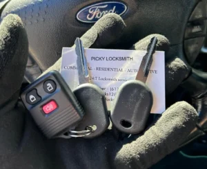 Ford car keys with remote fob duplicated by Picky Locksmith inside a vehicle.